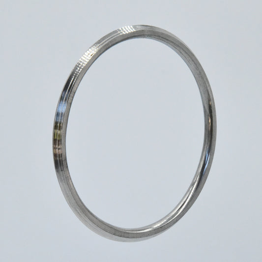 Steel kara on a light gray background