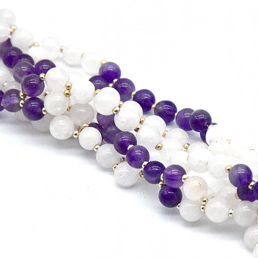 Necklace with white and purple beads on a white background