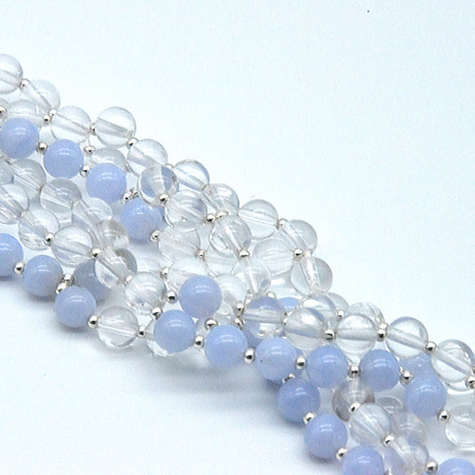 Beaded bracelet with blue and clear beads on a light blue background