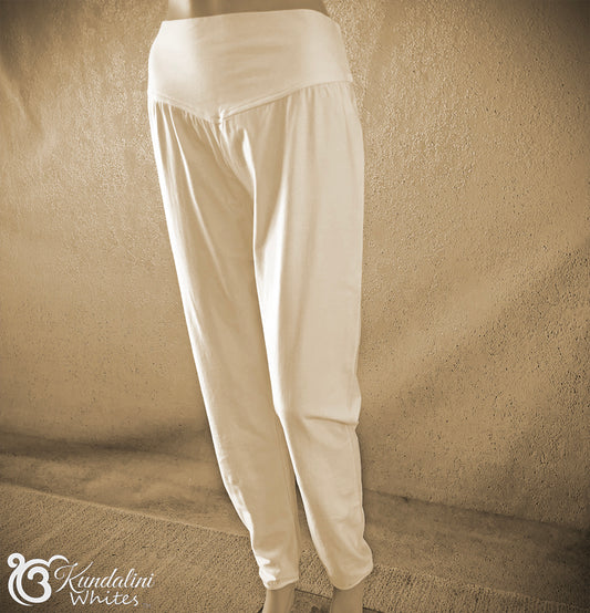 White pants on a neutral background with 'Kundalini Whites' branding.