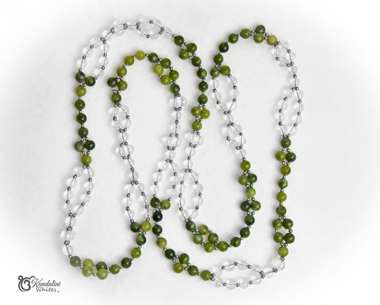 A Tantric necklace featuring green jade round beads alternating with clear quartzbeads, displayed on a clean white background.