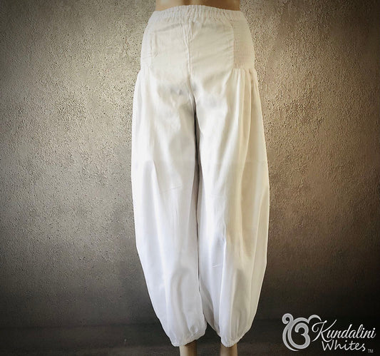 White wide-leg pants on a neutral background with 'Kundalini Writes' branding.