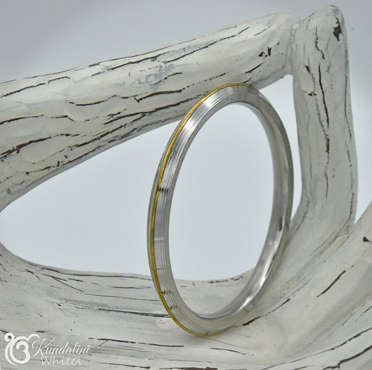 Decorative Kara bangle with white wooden frame and gold accent