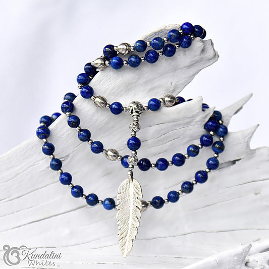 Lapis lazuli mala with a silver feather pendant on a white background