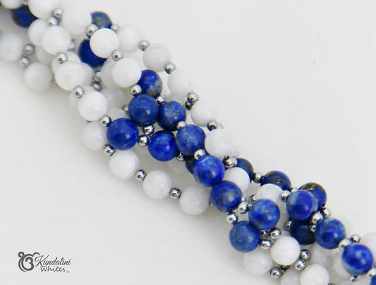 Tantric mala necklace with blue, white, and silver beads on a white background