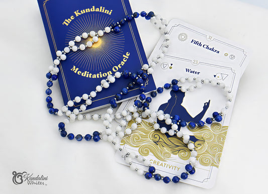 Kundalini Meditation Oracle cards with blue and white tantric necklace on a white background