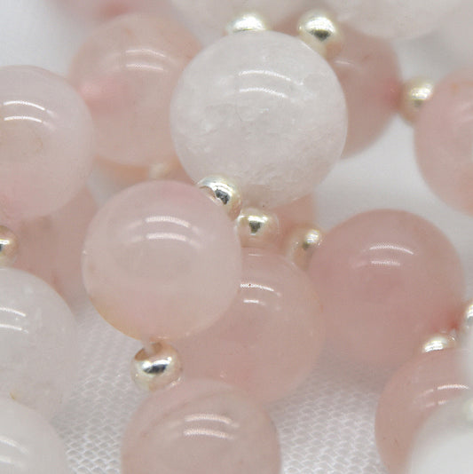 Close-up of pink and gold beaded bracelet on a white background