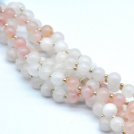 Beaded bracelet with pink and white beads on a white background