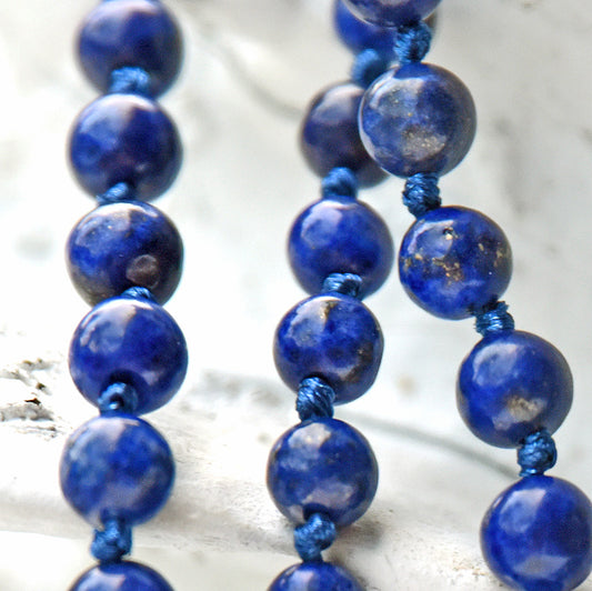 Necklace with blue beads on a light background