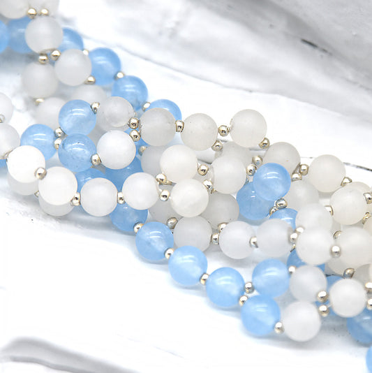 Close-up of blue and white beaded strands on a white background