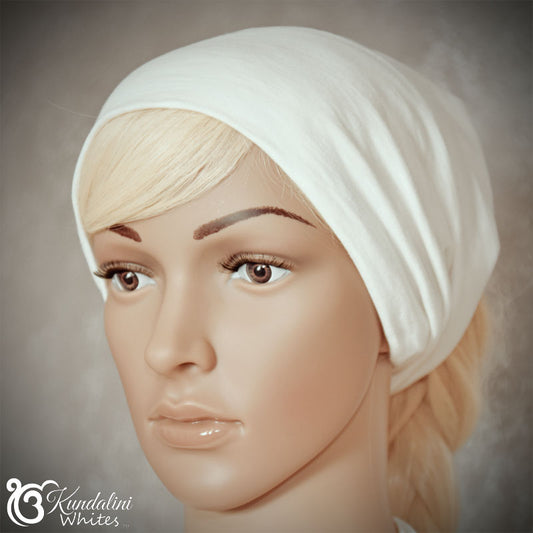 Mannequin head wearing a white headsband with 'Kundalini Whites' branding.