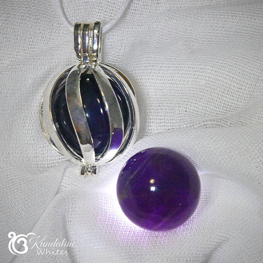 Silver and purple pendant on a white fabric background