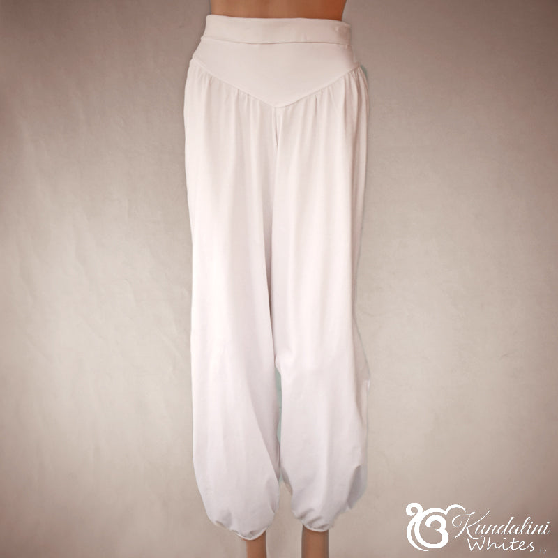 White wide-leg pants on a neutral background with 'Kundalini Whites' branding.