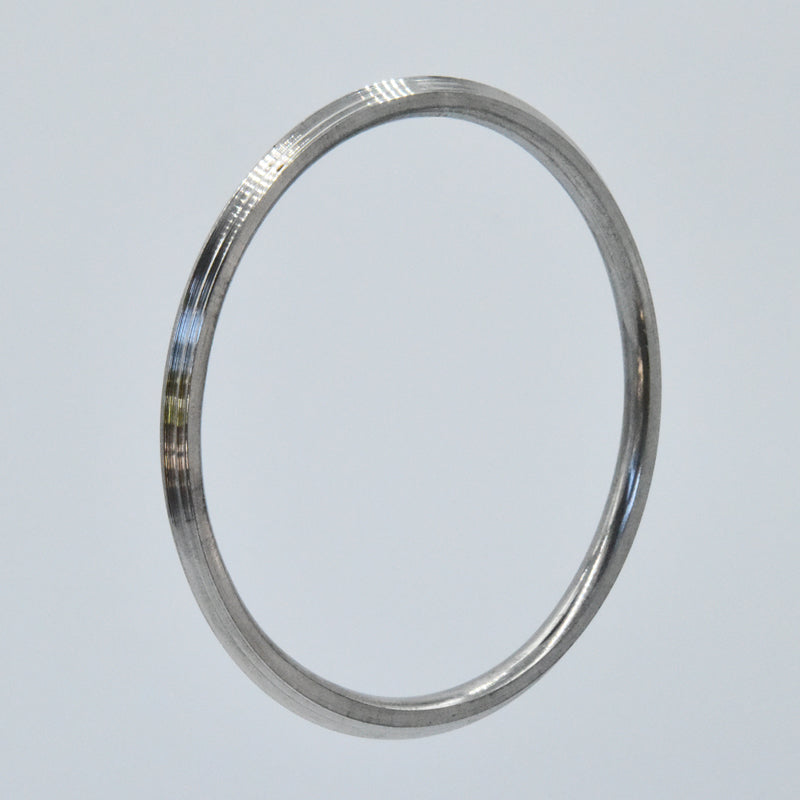 Steel kara on a light gray background