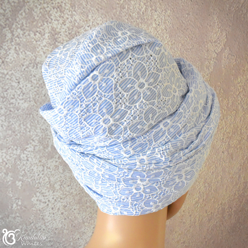 Light blue lace turban on a neutral background