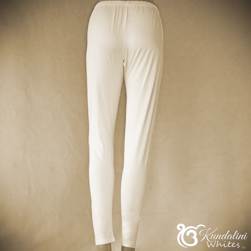 White pants on a beige background with 'Kundalini Whites' branding.