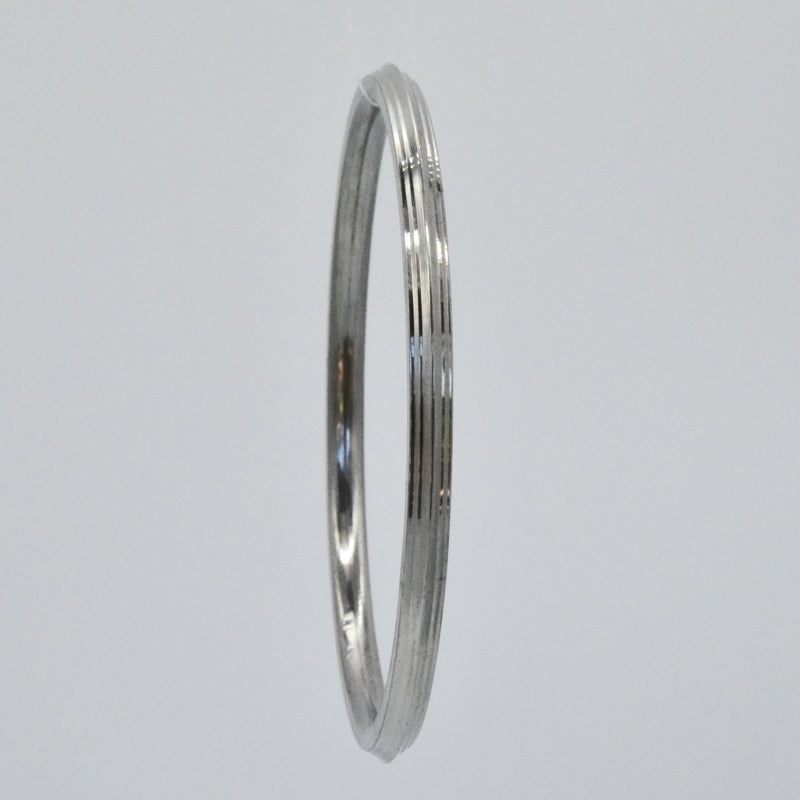 Steel kara on a light gray background