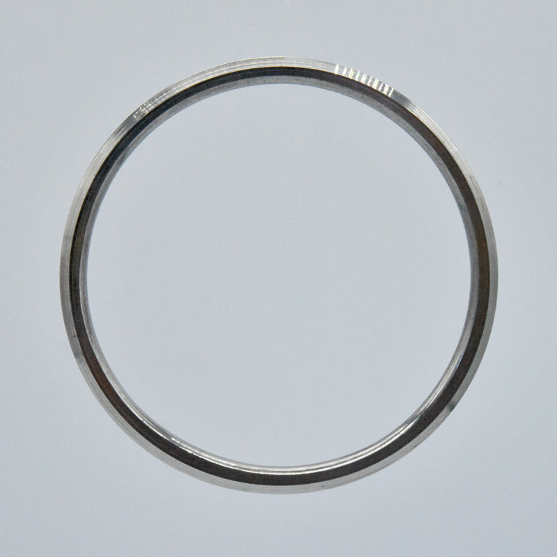 Steel kara on a light gray background