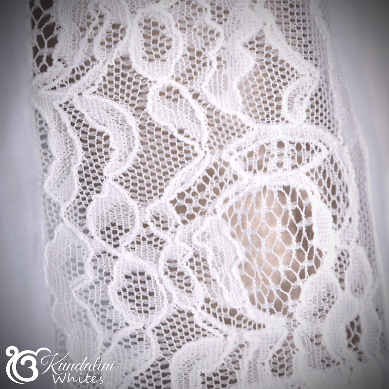 Close-up of white lace fabric with 'Kundalini Whites' branding.