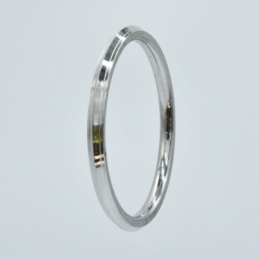 Steel kara on a light gray background