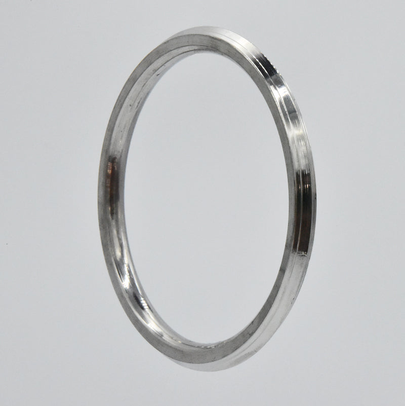 Heavy steel kara on a light gray background