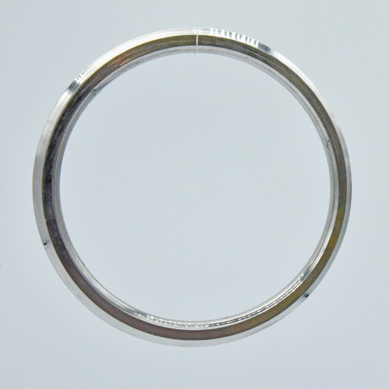 Heavy steel kara on a light gray background