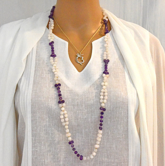 Long gemstone tantric mala for grace and spiritual depth on a mannequin.