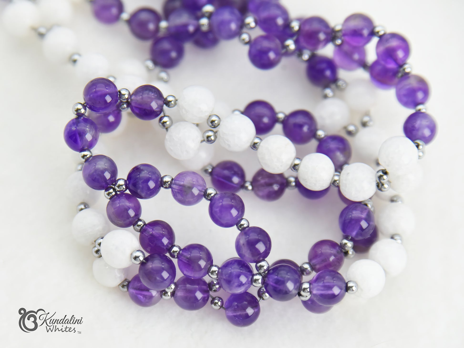 Purple and white tantric necklace closeup on a white background