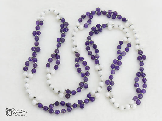 Purple and white beaded tantric necklace with silver accents on a white background