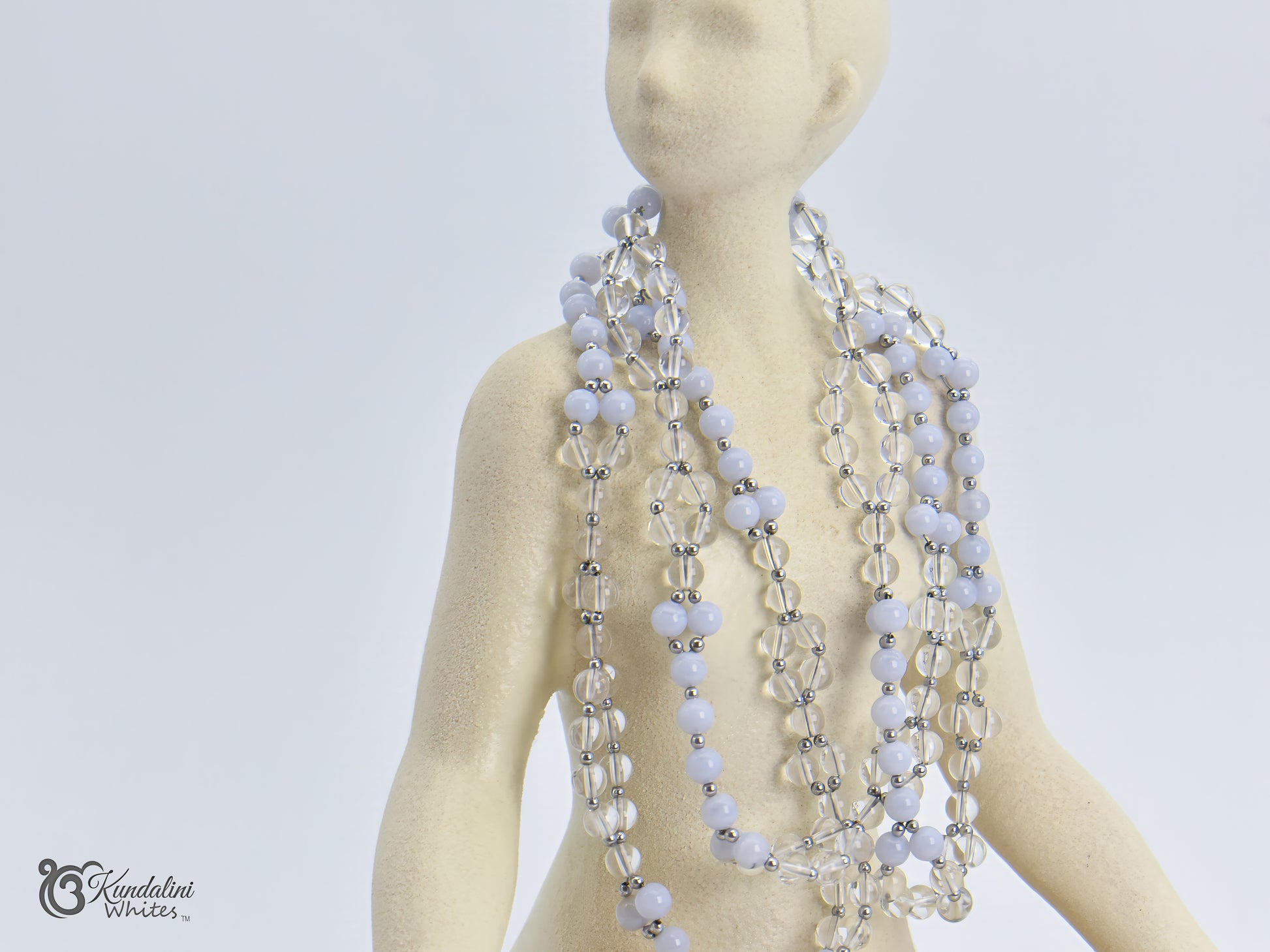 Tantric necklace on a mannequin against a plain background
