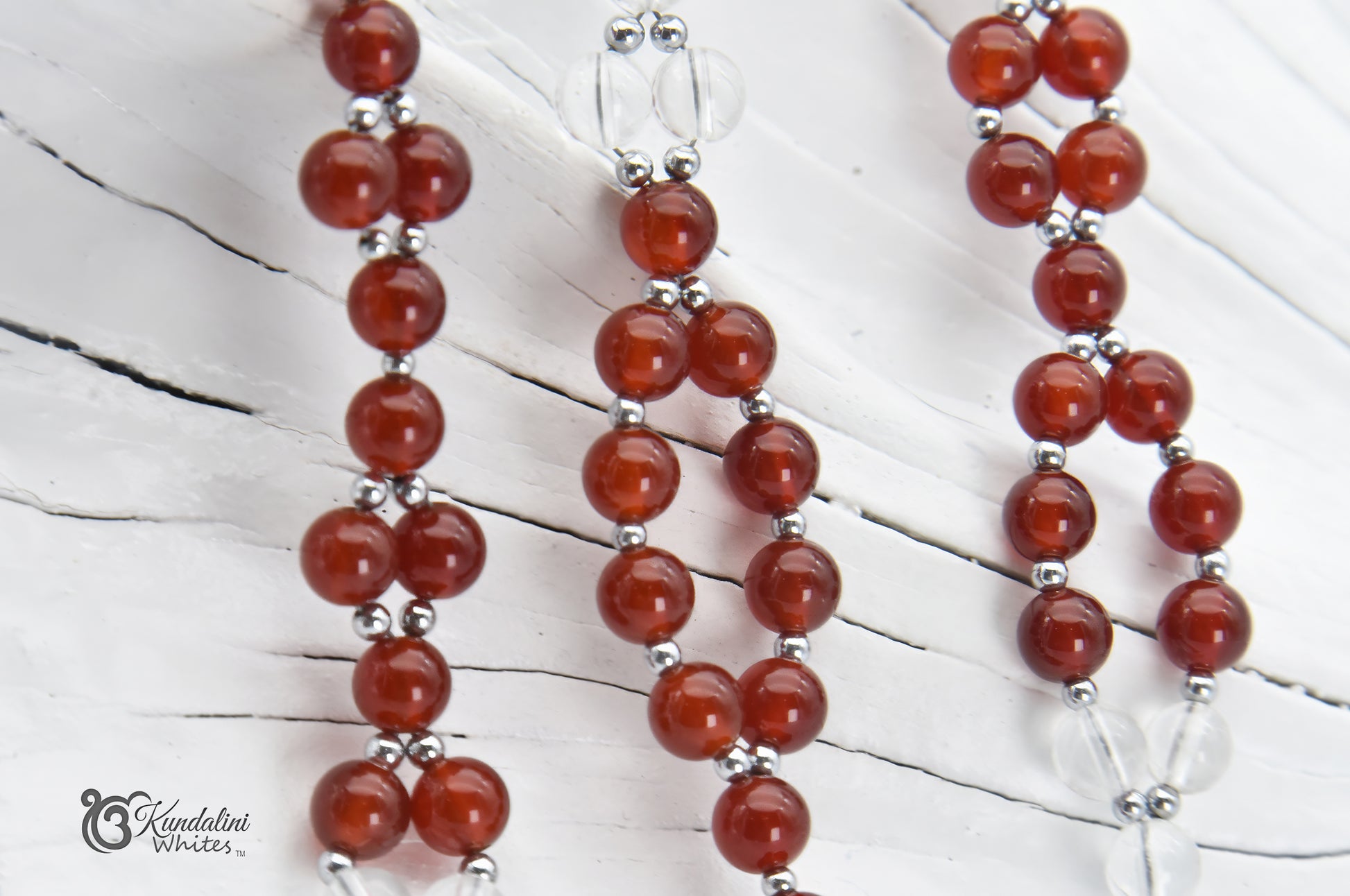 Red and clear tantric necklace closeup on a white background