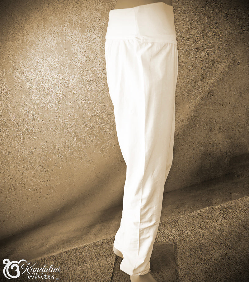 White pants leaning against a textured wall.