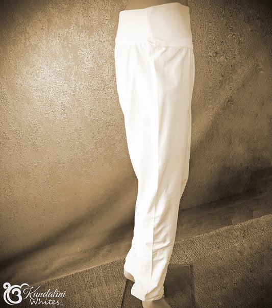 White pants leaning against a textured wall.