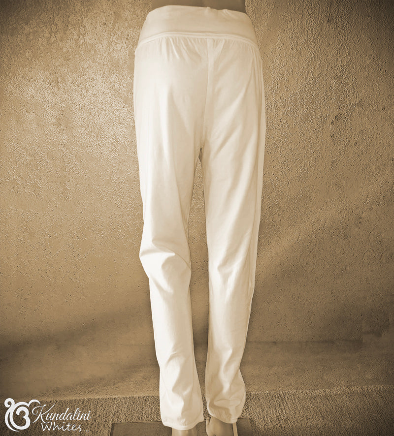 White pants against a textured beige wall