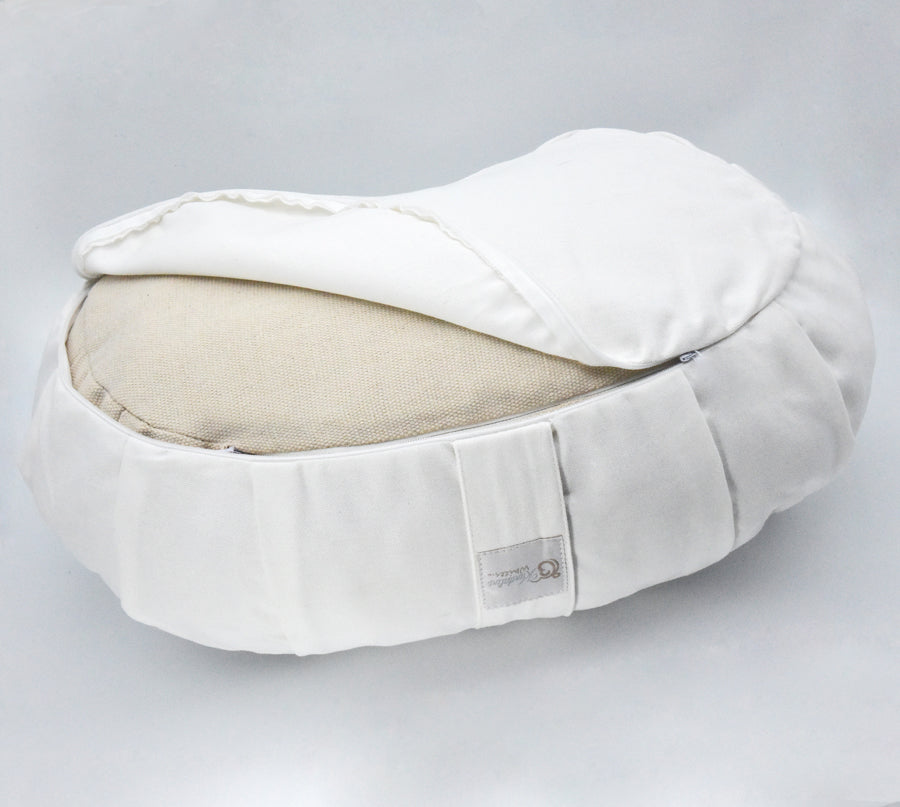 White and beige cushion on a light gray background