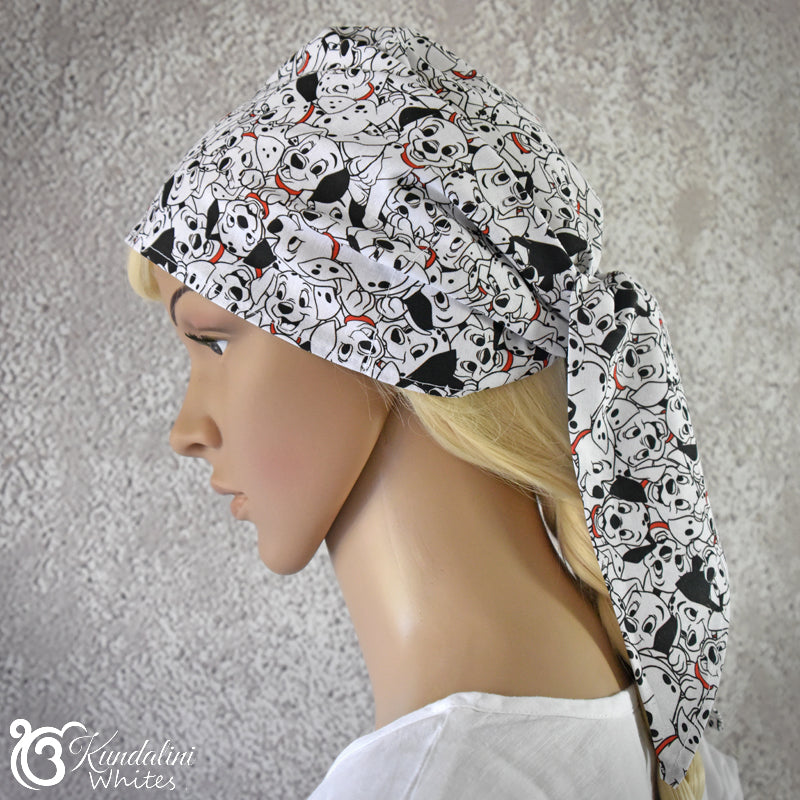 Mannequin head wearing a patterned headscarf with a neutral background