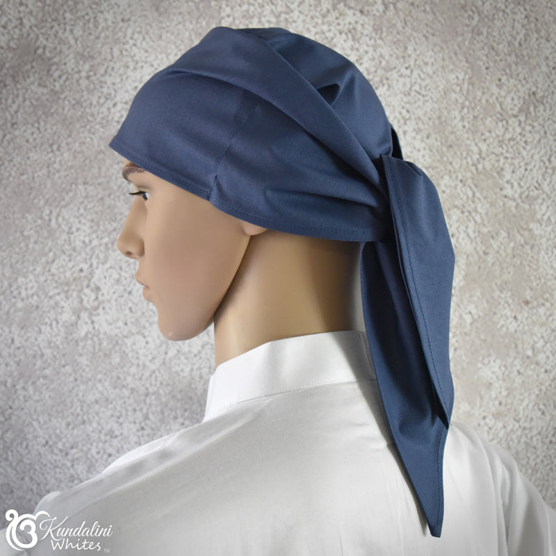 Mannequin head wearing a blue headscarf against a neutral background