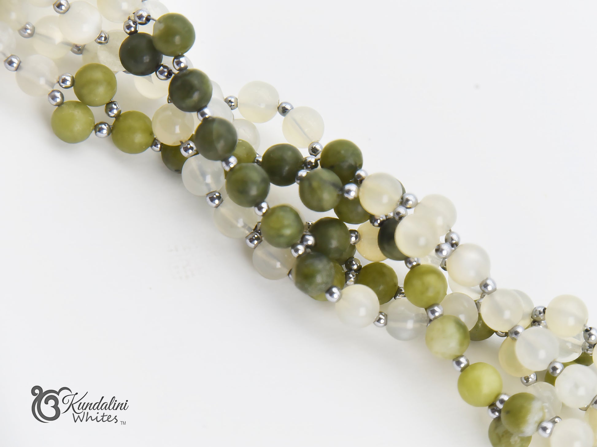 Tantric mala with green and white beads on a white background