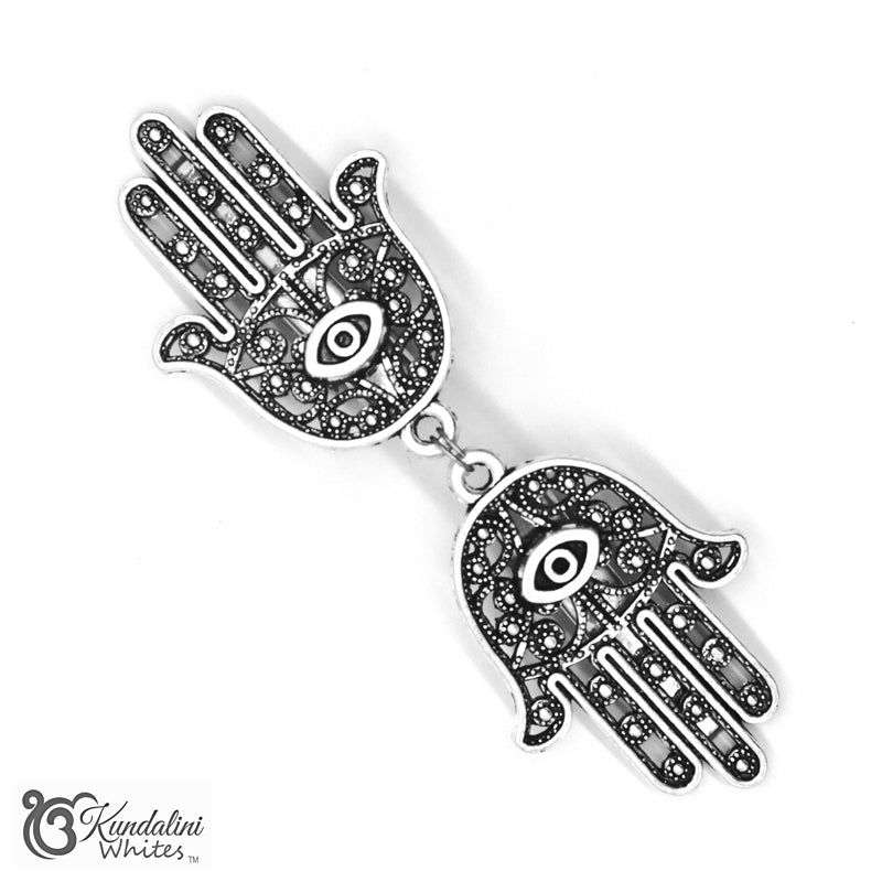 Silver Hamsa hand shawl holder with black stones on a white background