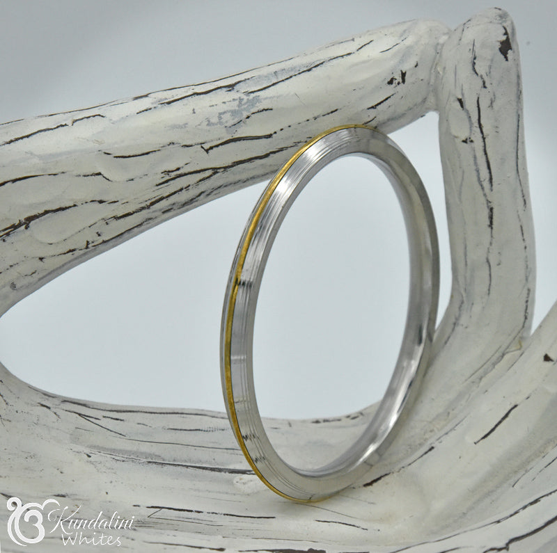 Decorative Kara bangle with white wooden frame and gold accent