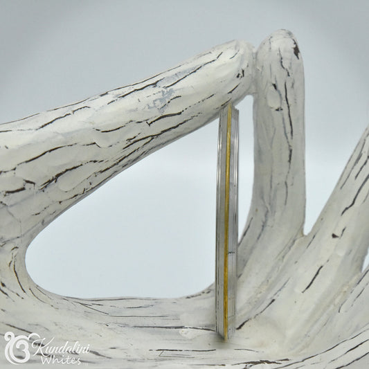 Decorative Kara bangle on a light gray background