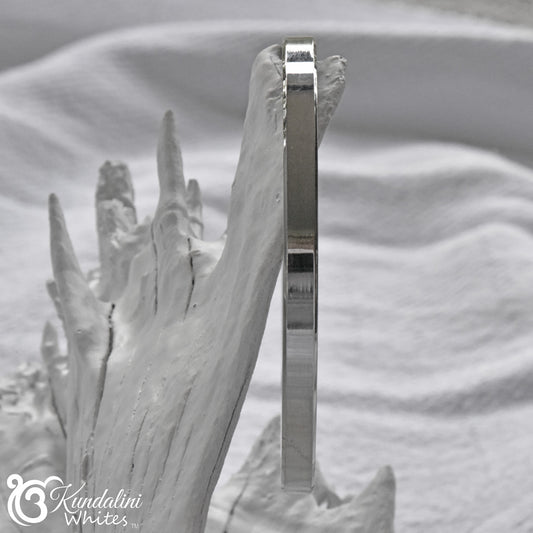 Steel Kara sideview on a textured white background with 'Kundalini Whites' branding.