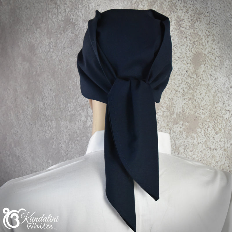 Navy blue scarf draped over a mannequin head against a textured gray background