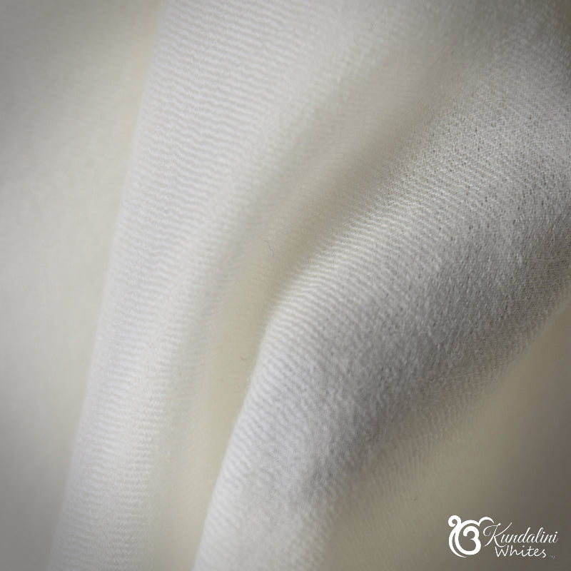 Close-up of white fabric with a subtle texture on a light background