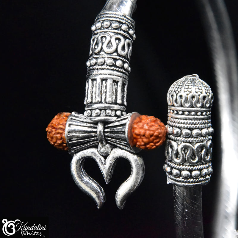 Silver bracelet with tribal Indian charm and orange beads on a black background