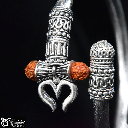 Silver bracelet with tribal Indian charm and orange beads on a black background