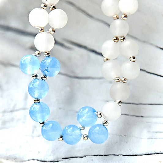 Necklace with blue and white beads on a light background