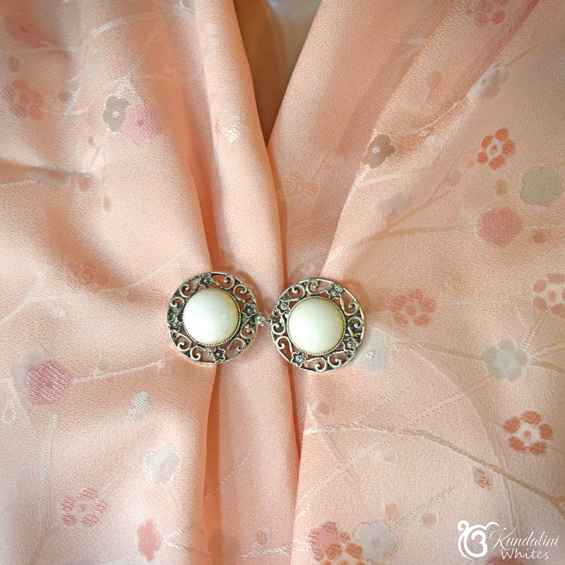 Floral scarf holder on a pink floral fabric background