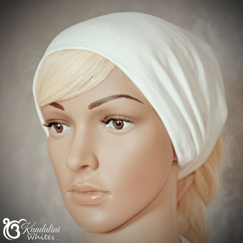 Mannequin head wearing a white headsband with 'Kundalini Whites' branding.