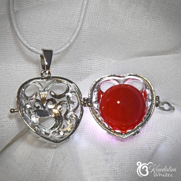 Heart-shaped crystal locket with carnelian